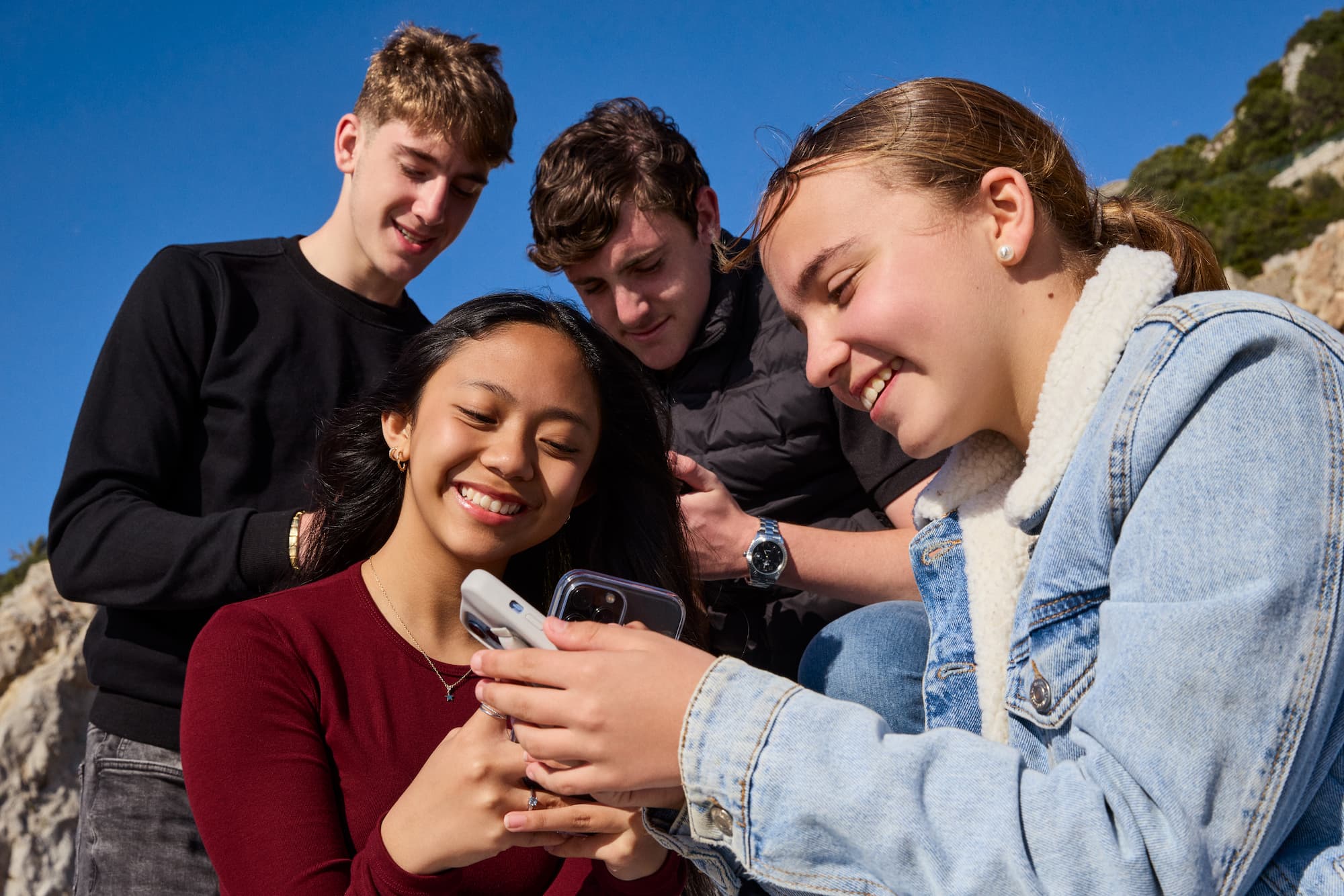 teenagers looking at their phones