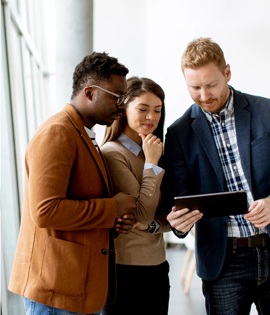 Three people looking at a tablet computer