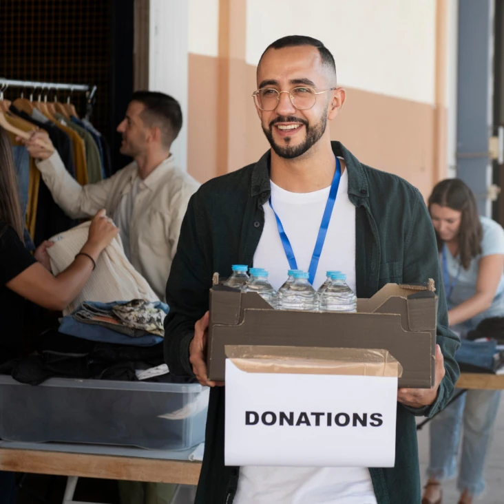 A person carrying a donations box